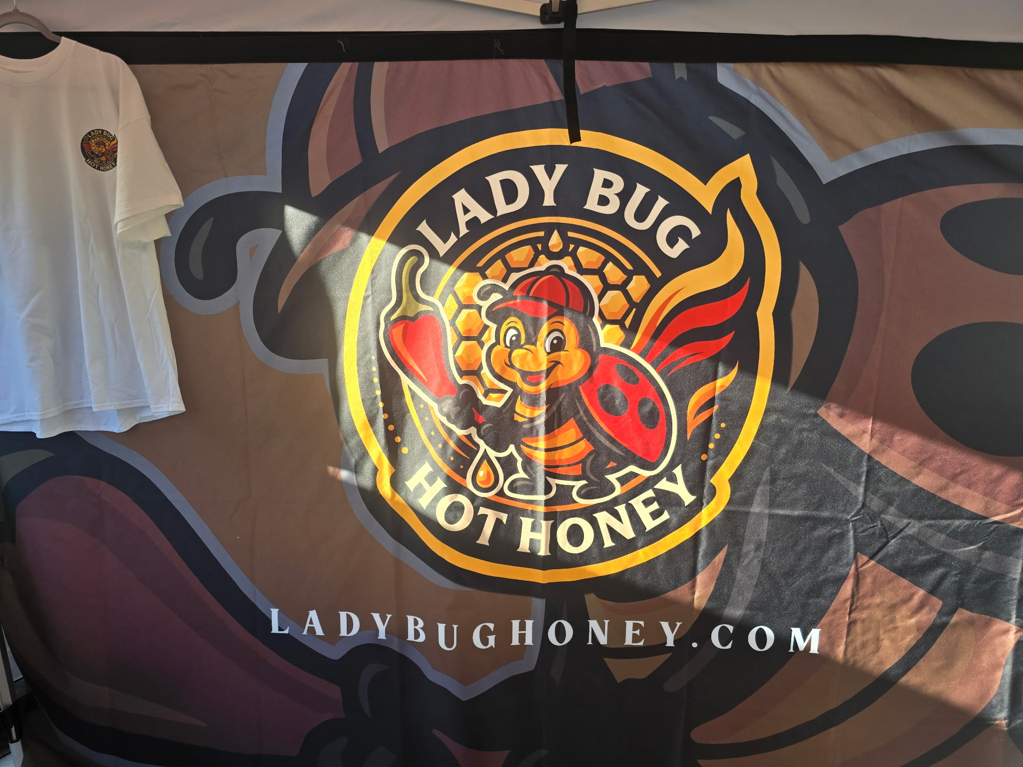 Close-up of LadyBug Hot Honey bottles ready to buy at the farmers market